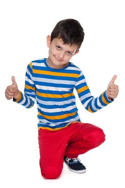 Happy young boy holds his thumbs up — Stock Photo, Image