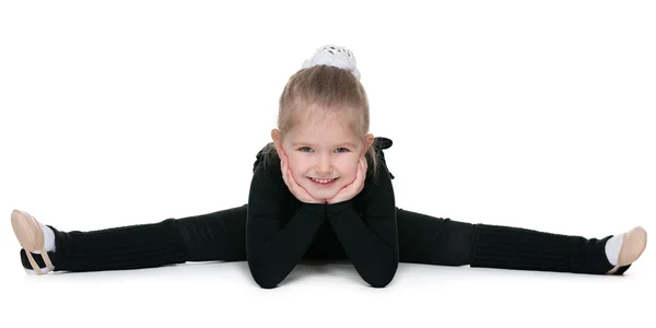 Pretty little girl performs gymnastic exercise — Stock Photo, Image