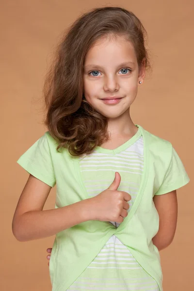 Little girl with her thumb up — Stock Photo, Image