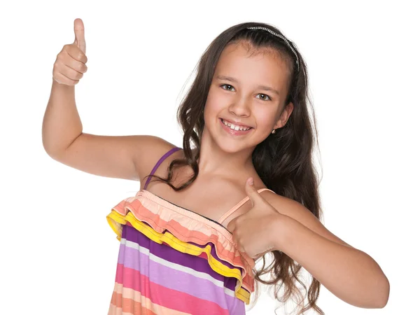 Happy preteen flicka håller sin tummen upp — Stockfoto