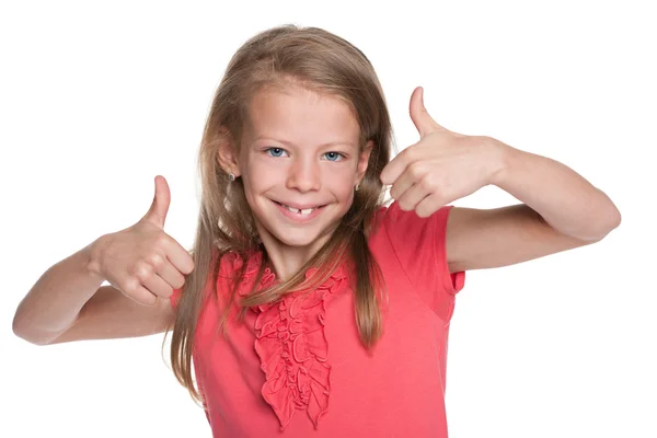 Sonriente niña sostiene sus pulgares hacia arriba — Foto de Stock