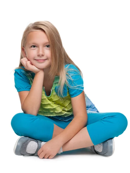 Blonde little girl sits on the floor — Stock Photo, Image