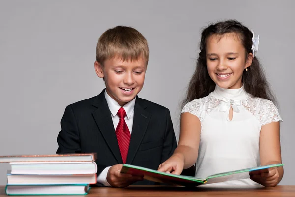 Niño y niña en el escritorio con libros —  Fotos de Stock