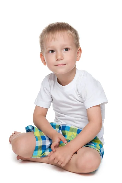 Preschool boy sits on the floor — Stock Photo, Image