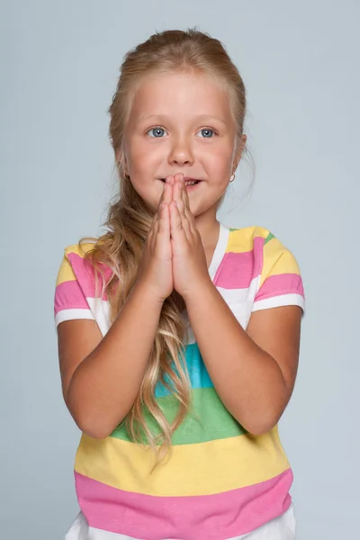 Joyful little girl against the gray background — Stock Photo, Image