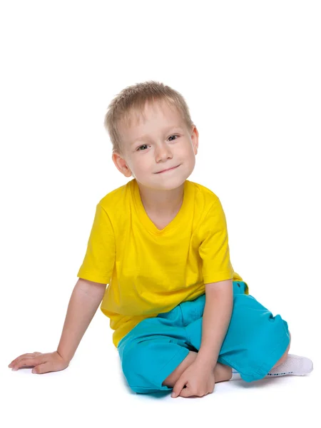 Cute little boy sits — Stock Photo, Image