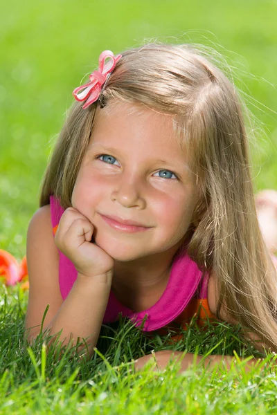 Little girl is on the green grass — Stock Photo, Image