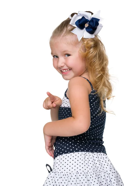 Laughing little girl shows her finger forward — Stock Photo, Image