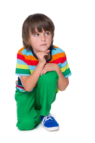 Pensive young boy in the green pants — Stock Photo, Image