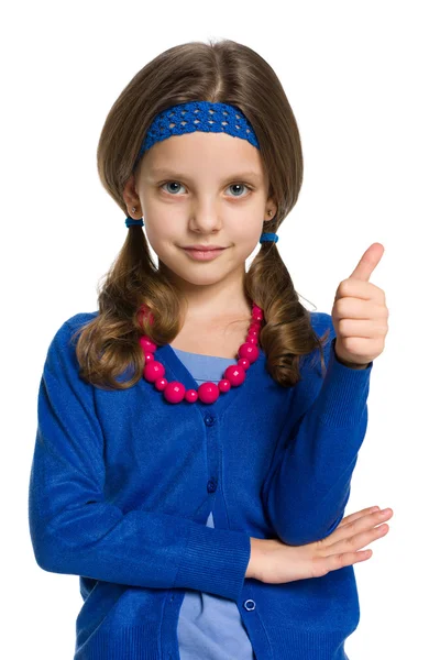 Smiling little girl holds her thumb up — Stock Photo, Image