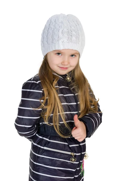 Little girl in a winter coat holds her thumb up — Stock Photo, Image