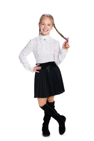 Улыбающаяся школьница с косичками — стоковое фото