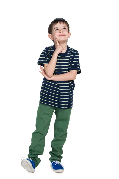 Smiling little boy in a striped shirt looks up — Stock Photo, Image