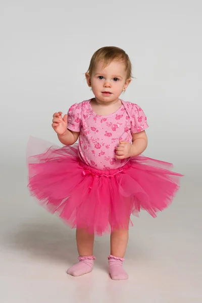 Little girl stand against the gray background — Stock Photo, Image