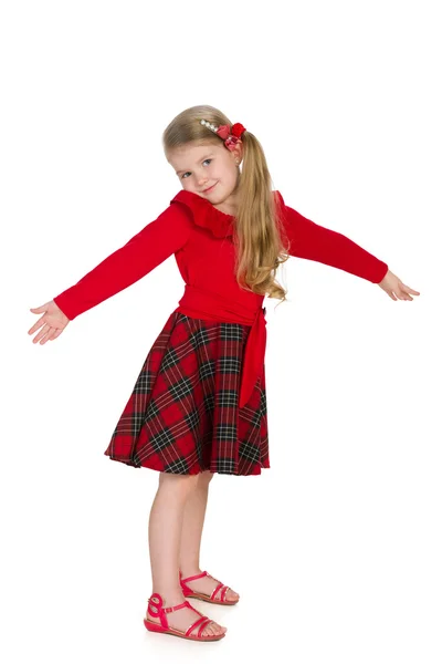 Lovely little girl stands against the white — Stock Photo, Image