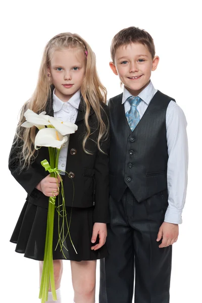 Mladý chlapec a hezká dívka s květinami — Stock fotografie