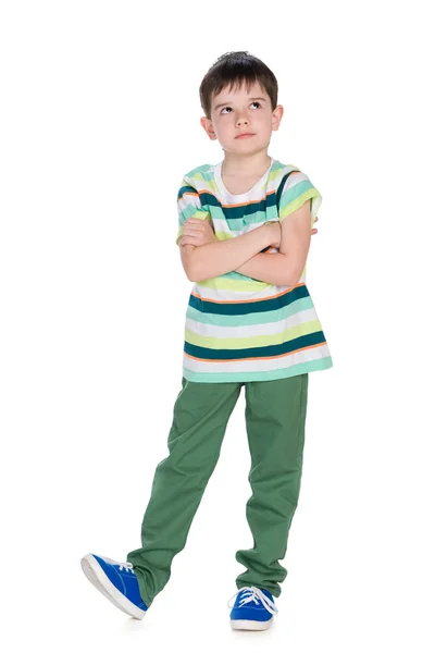 Cute little boy in a striped shirt looks up — Stock Photo, Image