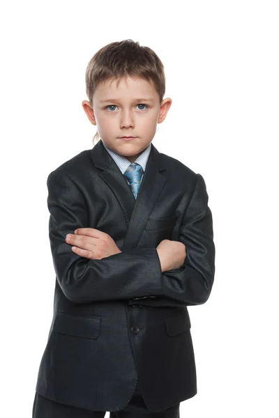 Ernstige jongen in een pak met zijn handen gekruist — Stockfoto