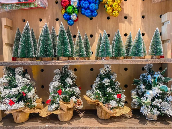 Apró karácsonyfák és színes csecsebecse eladó a boltban — Stock Fotó