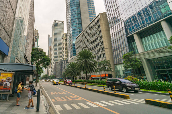 Makati, Metro Manila, Philippines - August 2018: Ayala Avenue and modern financial office towers in Makati City