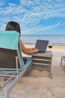 Freelancer work from home on laptop at the beach