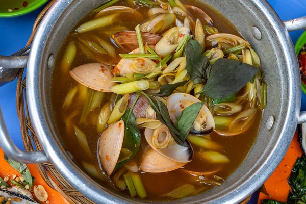 Bowl of spicy clams cooked with lemongrass, chili and tamarind