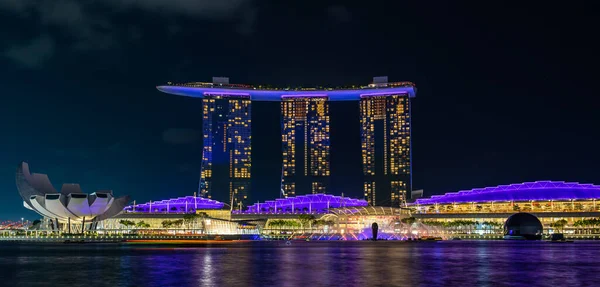 SINGAPORE - January 31, 2020: Marina Bay Sands hotel illuminated with purple neon light Stock Photo