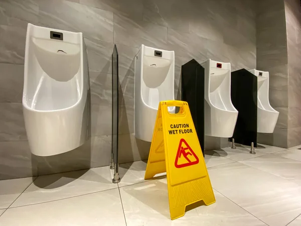 Znak ostrzegawczy mokrej podłogi podczas czyszczenia w publicznej toalecie — Zdjęcie stockowe