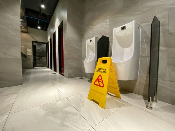 Wet floor alert sign in men toilet — Stock Photo, Image