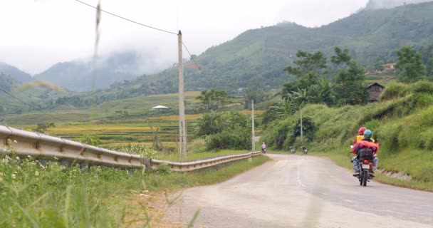 Cinematic shot on the road in countryside of Asia with motorbiker travelers. — Stock Video