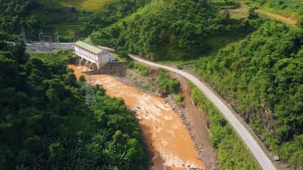 Vista aérea de una central hidroeléctrica con río sucio y bosque verde. — Vídeos de Stock