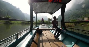 Teknede kamerayla konuşan genç bir turist görüntüsü..