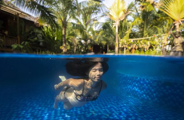 Vacker ung gravid kvinna under vatten i poolen split fotografi. — Stockfoto