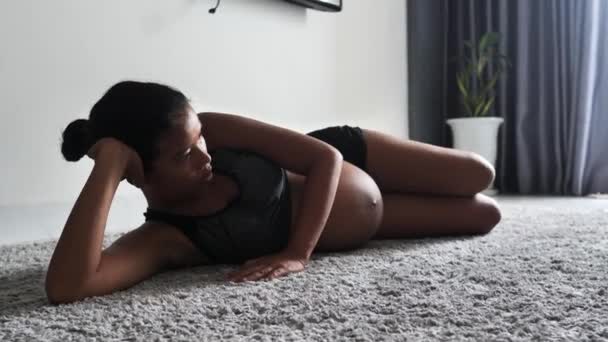Ung asiatisk gravid kvinde gør ben motion hjemme. – Stock-video