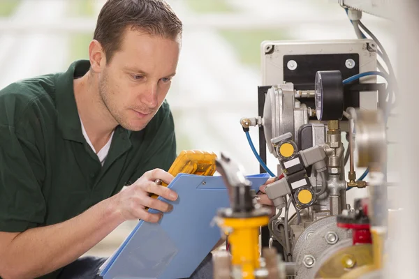 Male technician repairing agriculture machinery — Stock Photo, Image