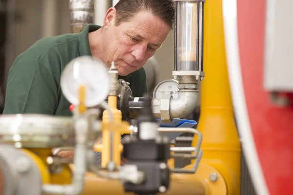 Male technician repairing agriculture machinery — Stock Photo, Image