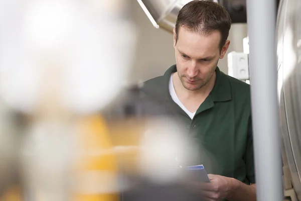 Male technician repairing agriculture machinery — Stock Photo, Image