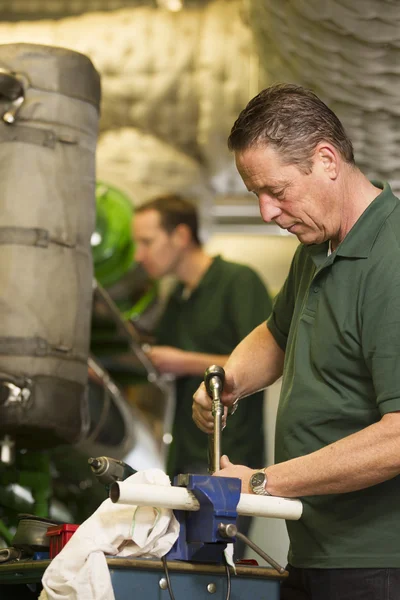 Two male technician repairing agriculture machinery — Stock Photo, Image