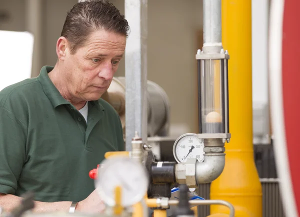 Male technician repairing agriculture machinery — Stock Photo, Image