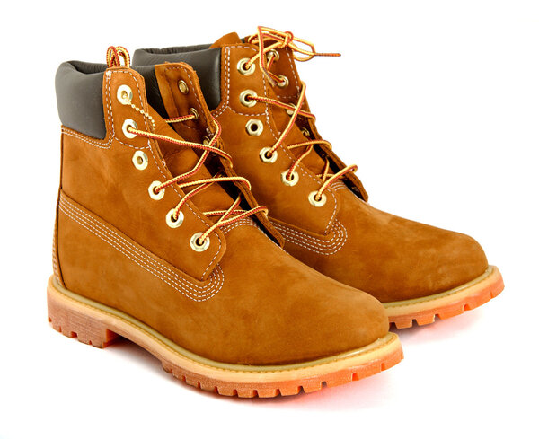 Brown ladys boots with shoelace on white background.
