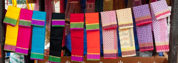 Telas coloridas y chales en un puesto de mercado — Foto de Stock