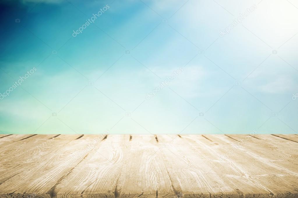 Wooden table with beautiful cloudy sky