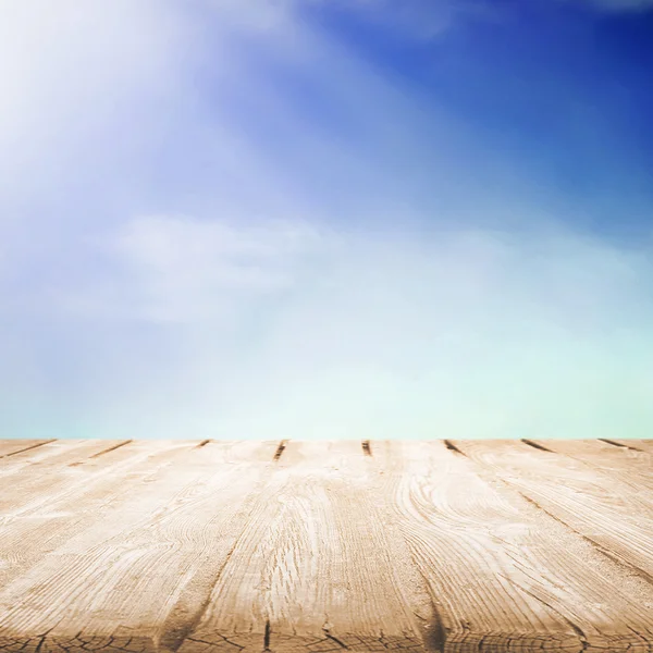 Wooden table with beautiful cloudy sky — Stock Photo, Image