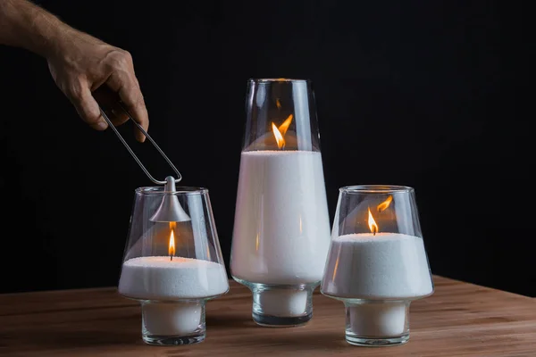 Hand extinguishes the candles. Candles smoke. Black background — Stock Photo, Image