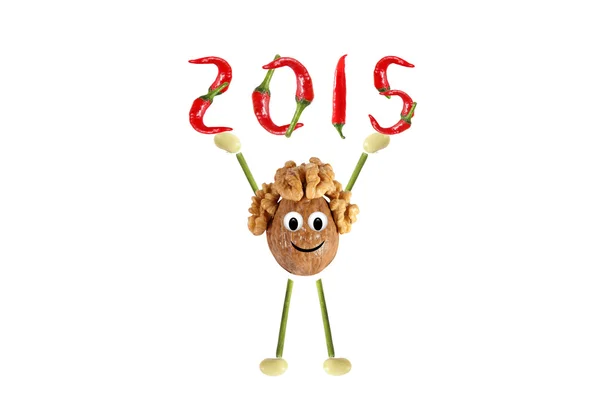 Healthy eating. Funny little man of the walnut raises 2015. — Stock Photo, Image