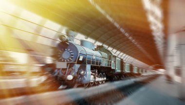 Steam train arriving at the station. Vintage look.  Motion blurr clipart