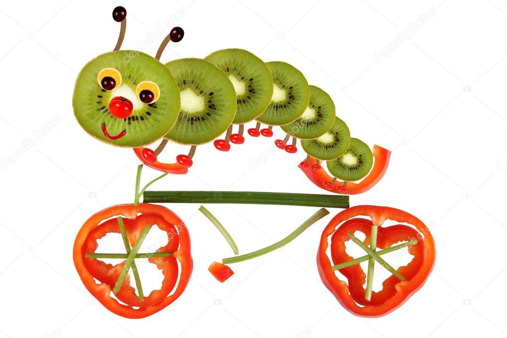  Creative food concept. Funny little caterpillar on a bicycle ma