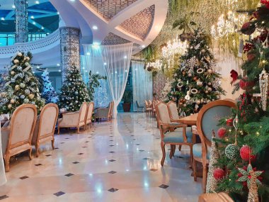 Yeni yıl restoranının içinde. Oyuncak, top ve yıldızlarla süslenmiş Xmas ağacı.