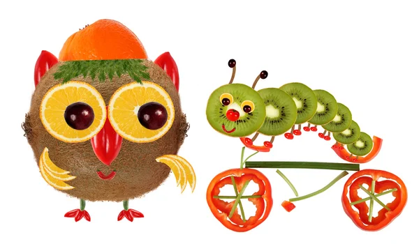 The little owl and a caterpillar on a bicycle made from vegetabl — Zdjęcie stockowe