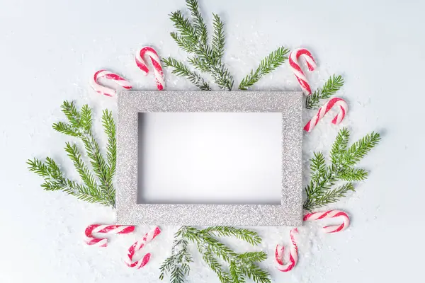 Frame for writing text,copy space.New Year\'s card from a frame and fir branches and sweets.
